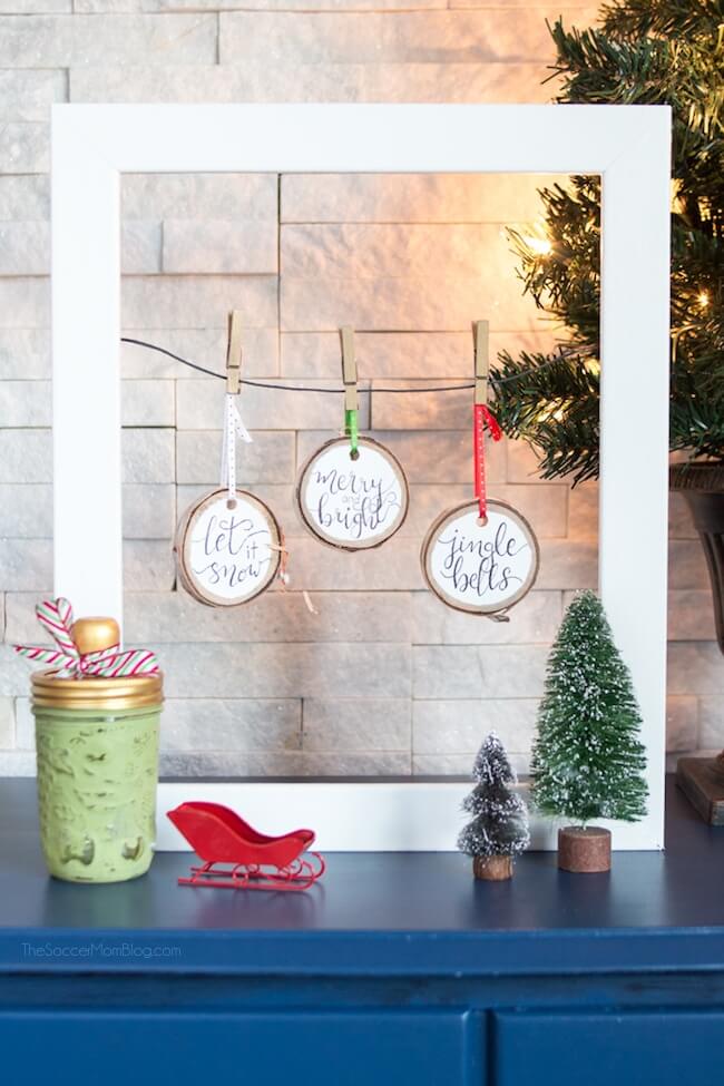 Click for easy VIDEO and photo step-by-step tutorial to make beautiful, rustic Hand Lettered Wood Slice Ornaments. Cute holiday craft for kids and adults!