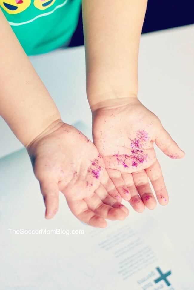 kids hands covered in glitter