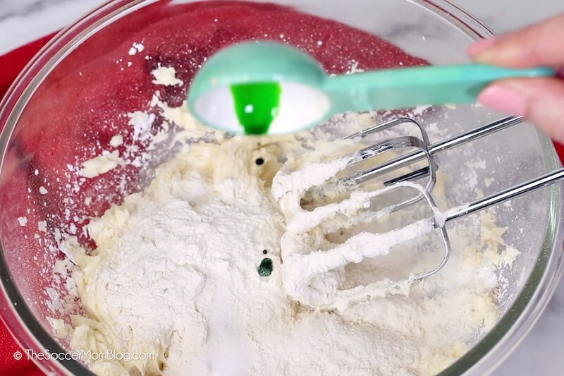 adding green food coloring to cookie dough