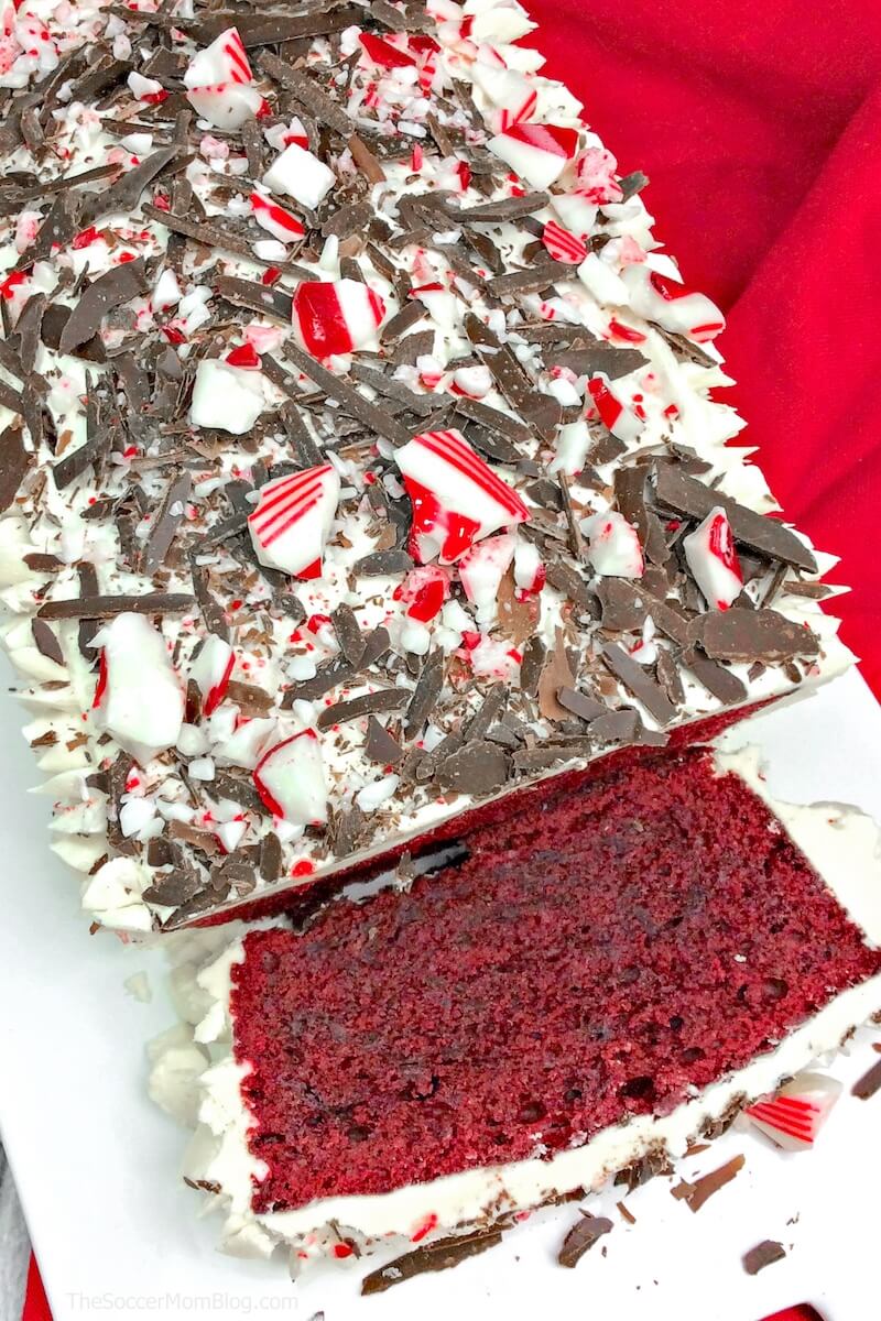 red velvet pound cake topped with cream cheese icing, peppermints, and chocolate shavings