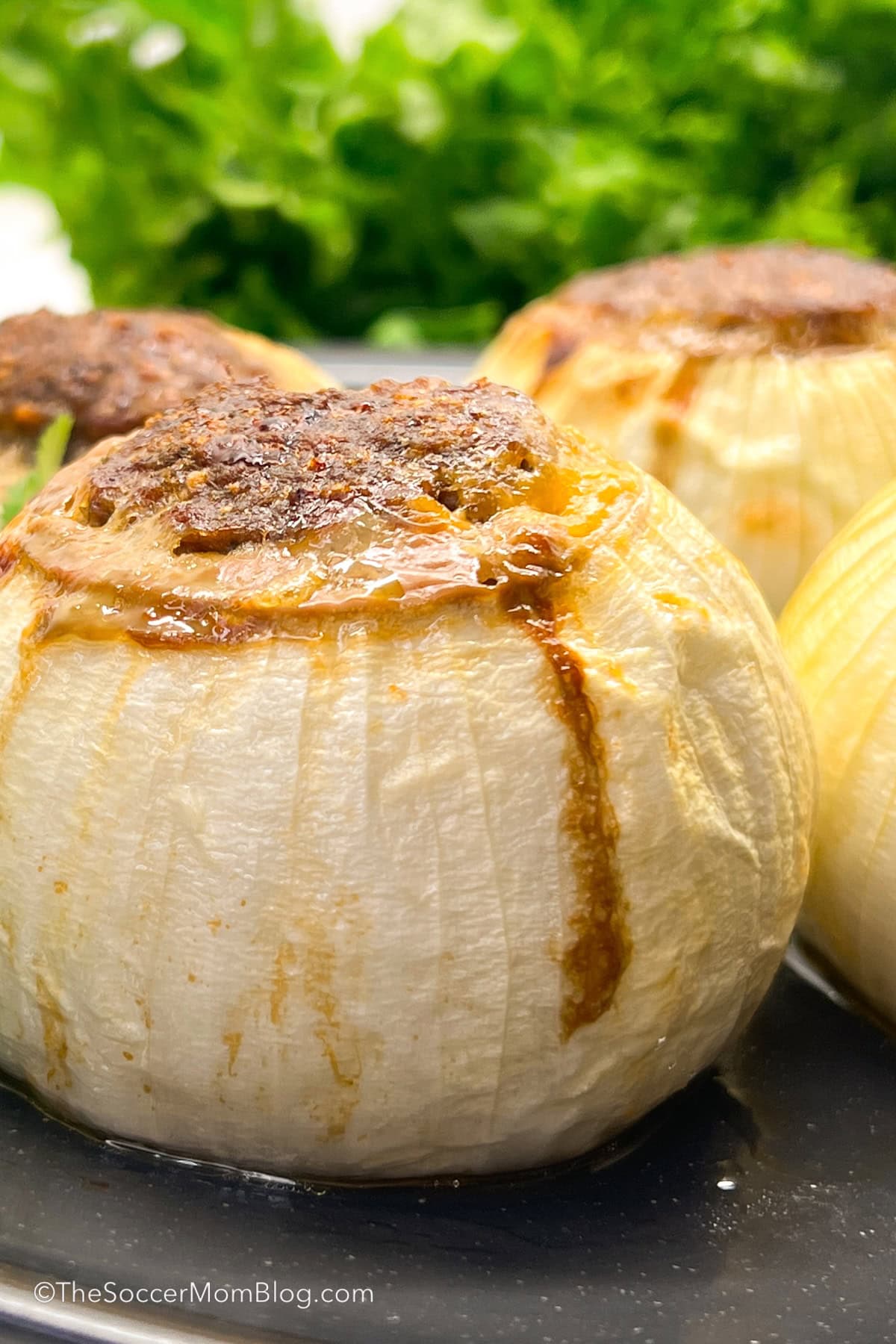 close up of a stuffed onion bomb filled with ground beef and cheese.