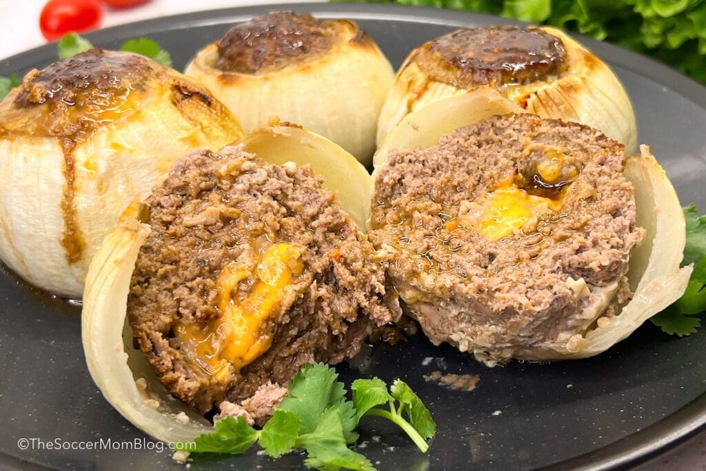 a ground beef stuffed onion cut open to show the filling.