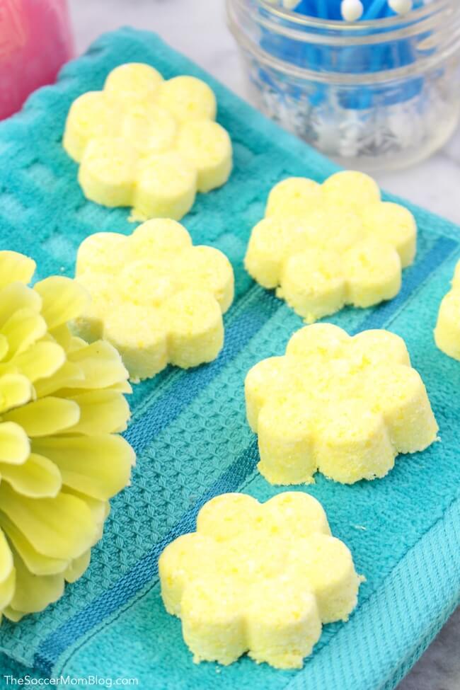 batch of homemade citrus shower steamers on blue towel