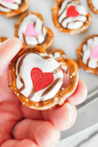 holding a Valentine heart pretzel treat