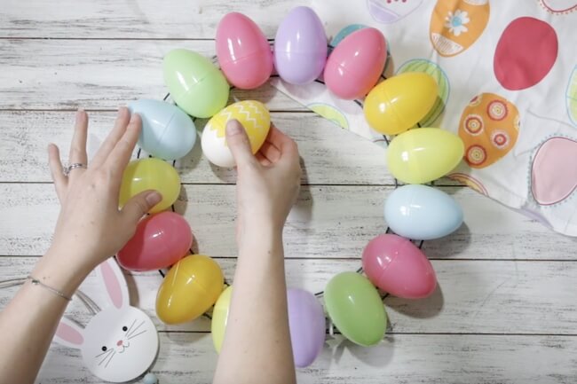 gluing plastic Easter eggs to make a Spring wreath