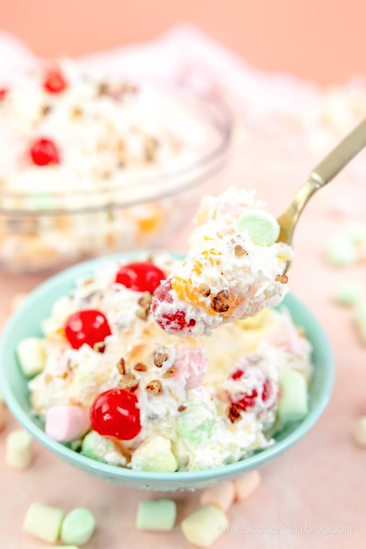 ambrosia salad in bowl, with a spoonful up close