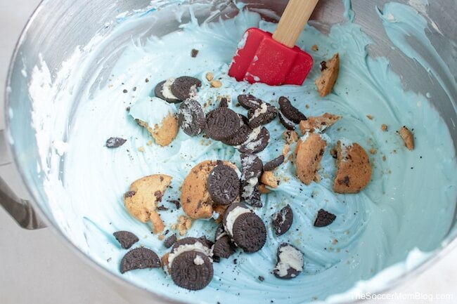adding cookies to cheesecake batter