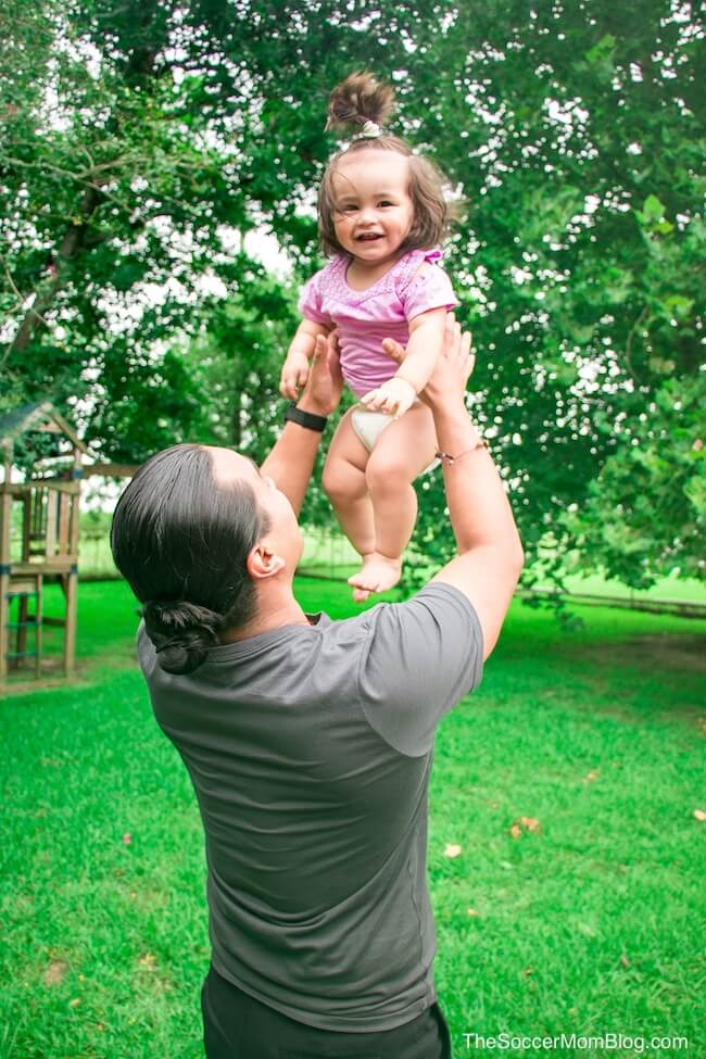 dad tossing laughing baby in the air