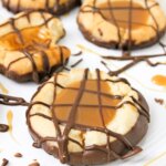 thumbprint cookies filled with caramel and topped with chocolate drizzle.