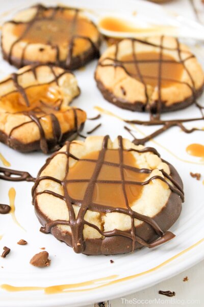 thumbprint cookies filled with caramel and topped with chocolate drizzle.