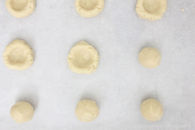 making thumbprint cookies on cookie sheet