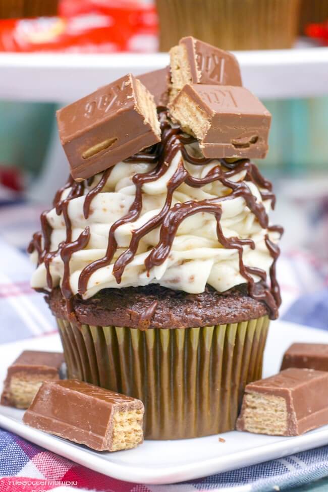 a big chocolate cupcake layered with frosting and Kit Kat bars