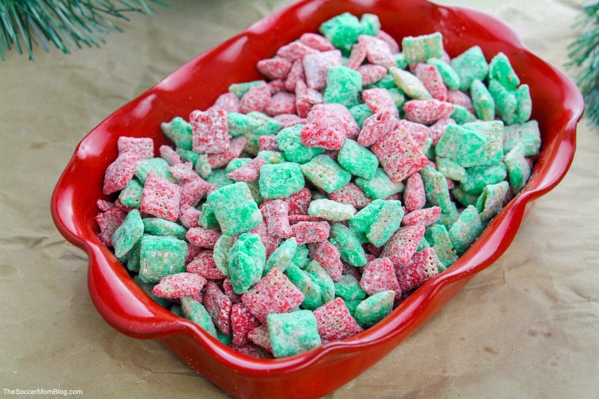 red dish with Christmas puppy chow snack mix