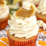 pumpkin pie cupcakes topped with a miniature slice of pumpkin pie