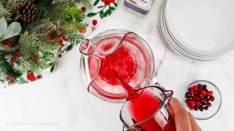 pouring cranberry juice into pitcher