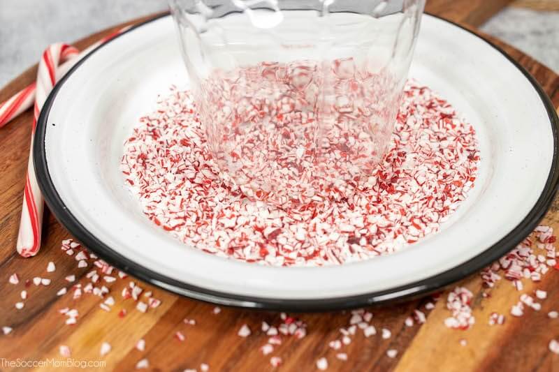 dipping the rim of a cocktail glass in crushed peppermints
