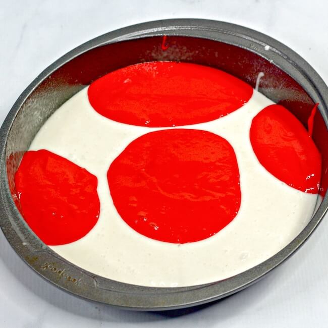 red and white cake batter in baking pan