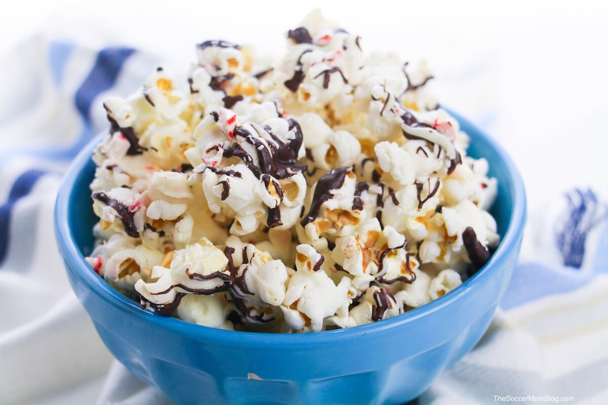 bowl of popcorn with chocolate and peppermint candy drizzle