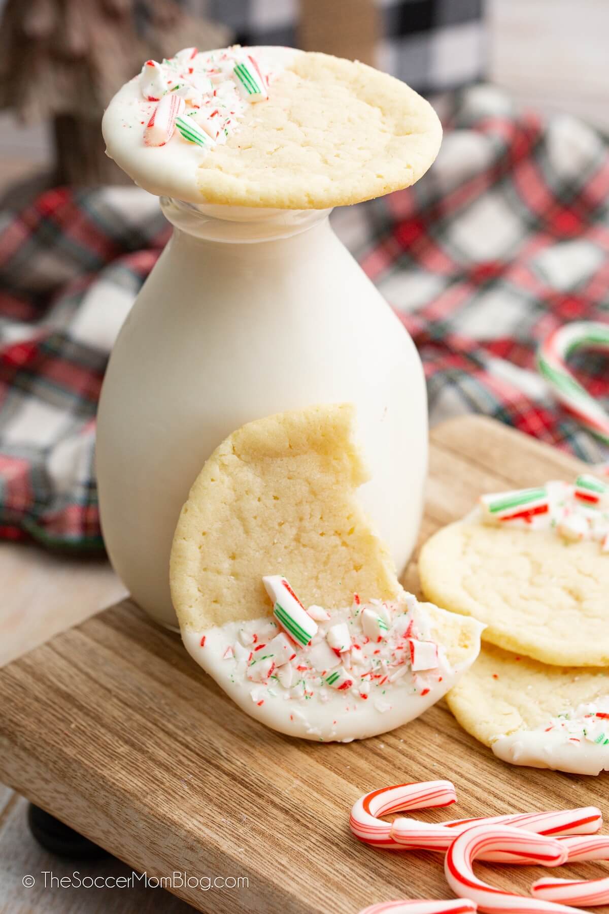 bottle of milk with peppermint cookies stacked on top