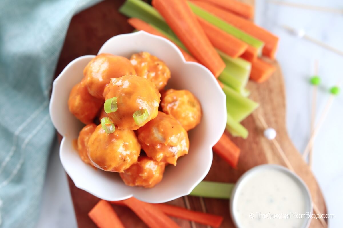 bowl of buffalo chicken meatballs with carrots and celery