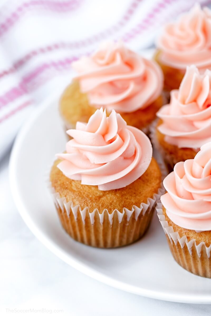 plate of pink champagne cupcakes with frosting