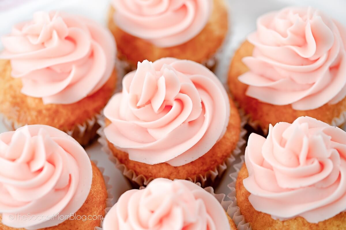 top-down view of cupcakes with light pink frosting.