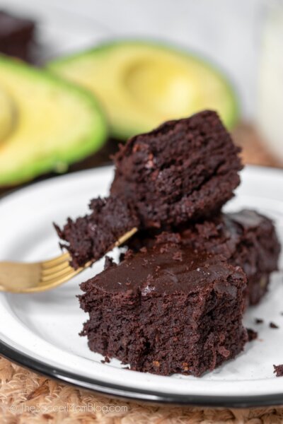 fudge brownies with halved avocados in background
