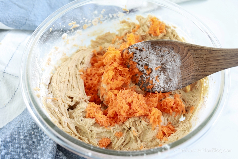 stirring shredded carrots into cookie batter