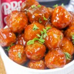 saucy meatballs piled in a white bowl next to Instant Pot
