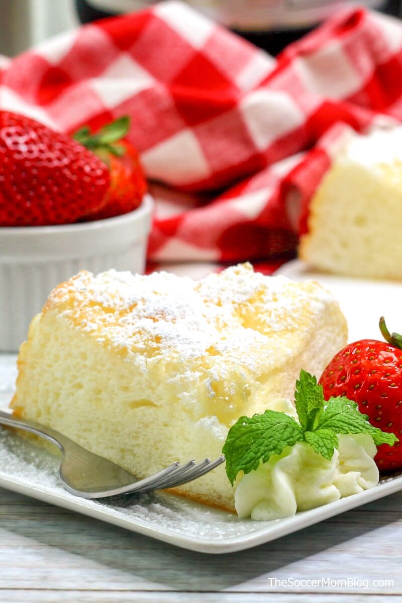 a slice of angel food cake with strawberries and powdered sugar