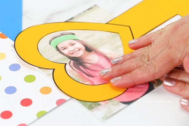 gluing child's photo to Key to My Heart card