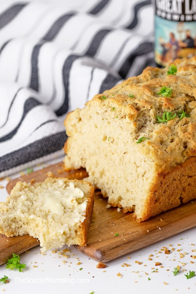 loaf of beer bread with a buttered slice