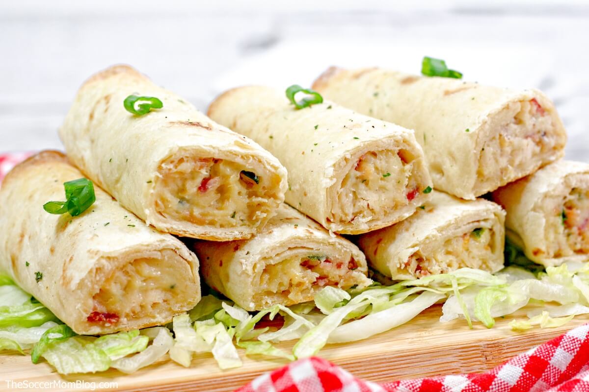 baked chicken taquitos on a bed of lettuce