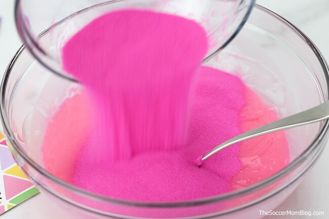 pouring hot pink sand into slime