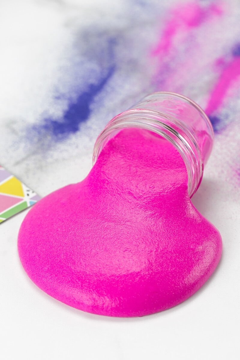 hot pink sand slime spilling out of a jar