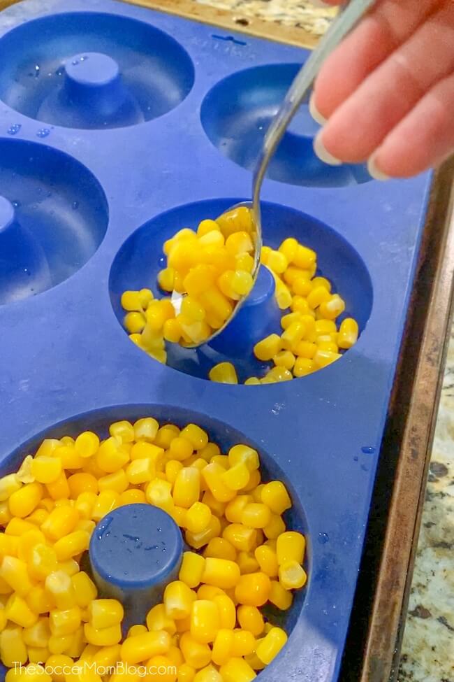 filling donut pan with corn 