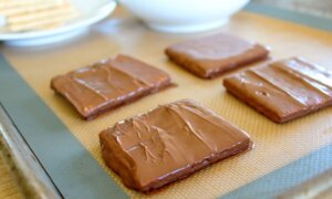 chocolate covered graham crackers on baking sheet