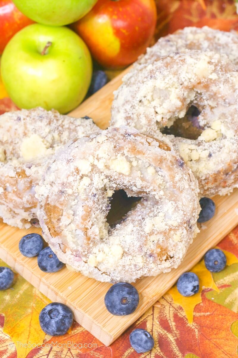 pile of baked apple blueberry donuts with streusel coating