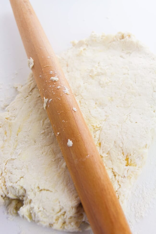 rolling biscuit dough with wooden pin