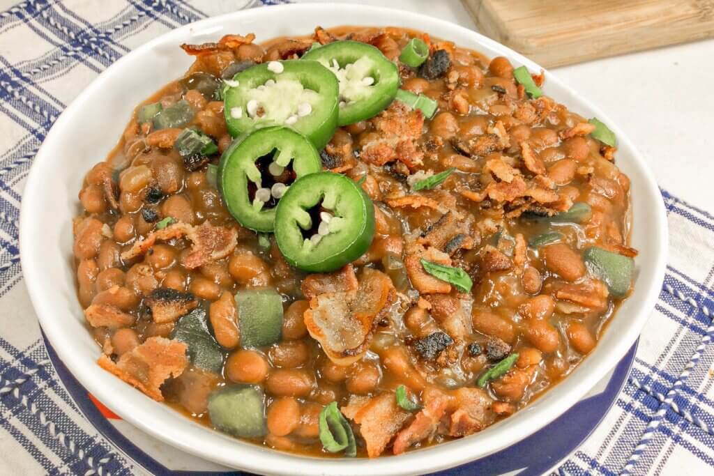 large bowl of homemade baked beans with jalapeños and bacon