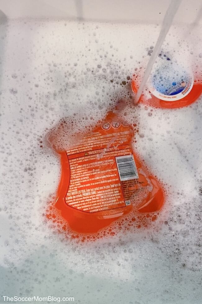 soaking laundry container in soapy water