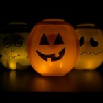 glowing DIY jack-o-lanterns made out of laundry detergent containers