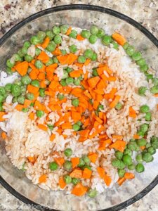 rice, peas, and carrots with soy sauce in bowl