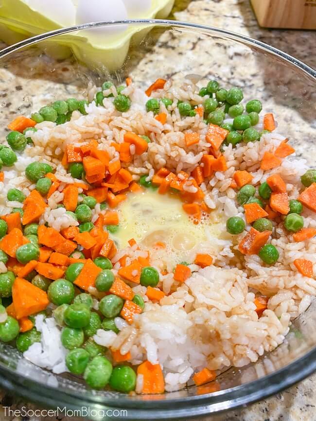 bowl of rice and veggies with scrambled egg in the middle