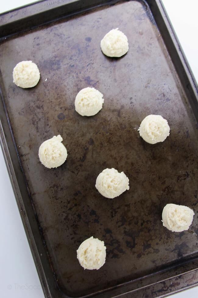 balls of sugar cookie dough on baking sheet