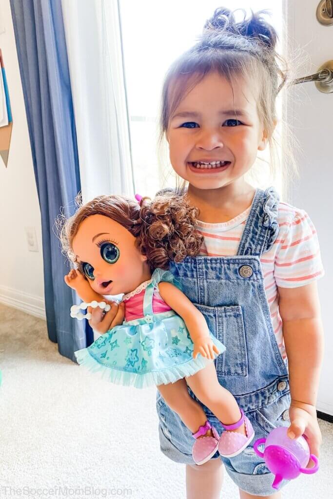 little girl holding baby doll