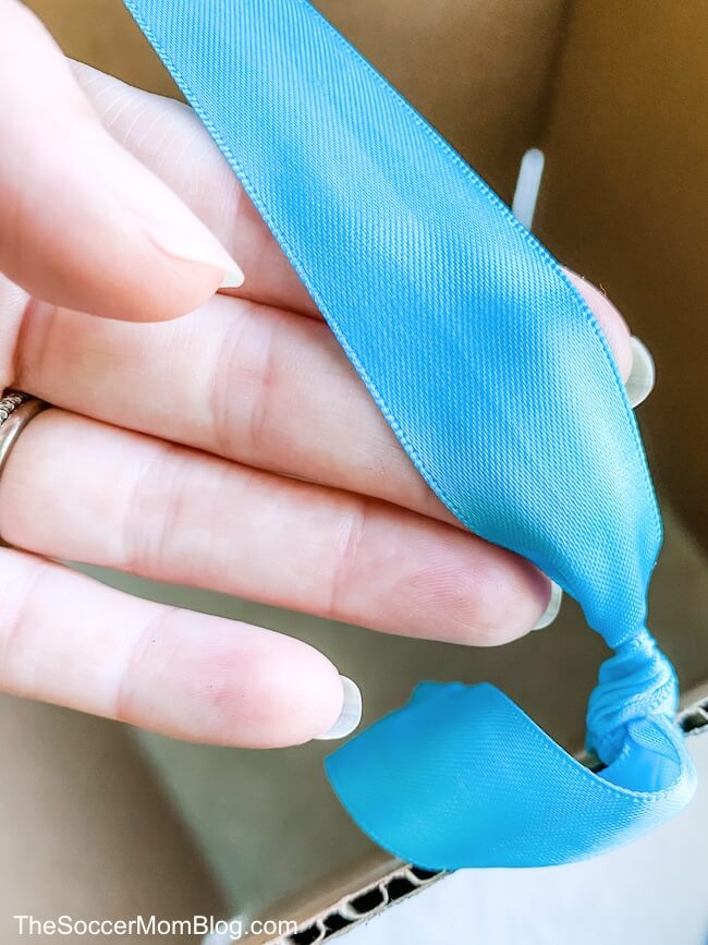 tying a ribbon on a cardboard box
