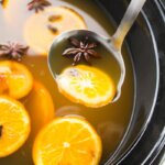 mulled apple cider ladled from slow cooker