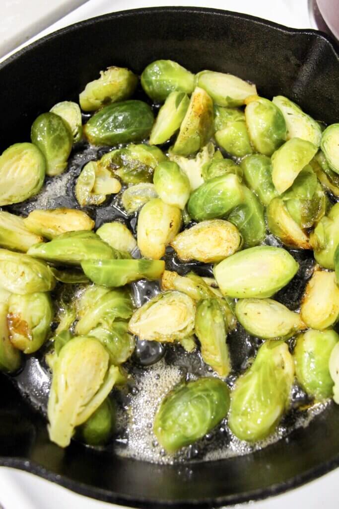 halved brussel sprouts cooking in pan