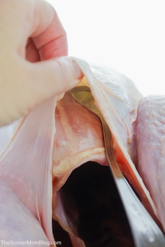 separating turkey skin from breast meat with spoon